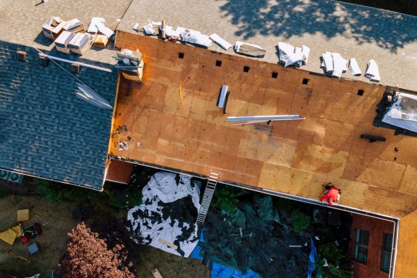 Working roofers on replacing the roof of residential building in the renovation roof the house