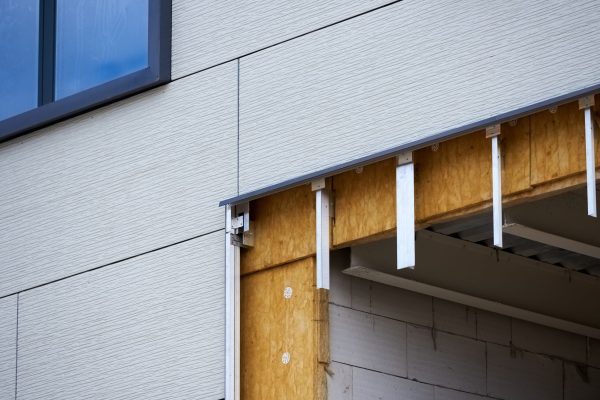 office building under construction. Facing and insulation of walls.