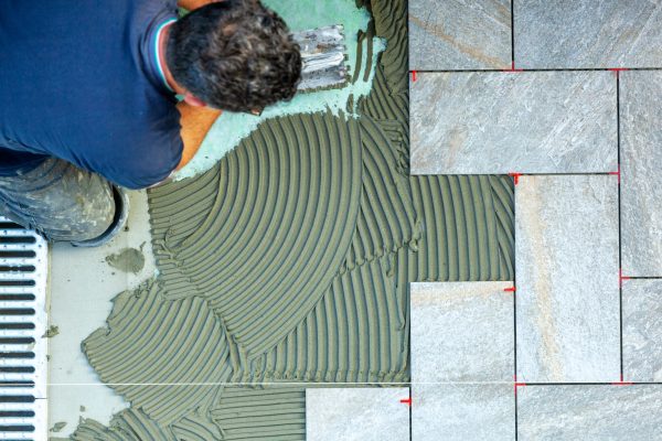 Spreading with trowel floor glue. View from above.